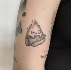 a woman with a tattoo on her arm holding a piece of food in her hand