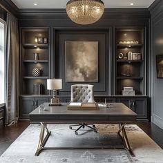 a home office with built in bookcases and chandelier