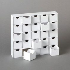 several white boxes stacked on top of each other with black heart shaped holes in them