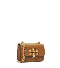 Directly from Tory Burch - Signature hardware, scaled-up in sculptural brass. From our Fall/Winter 2020 runway, the new Eleanor Small Bag is a structured shape in soft Italian leather - with edges that are painted by hand, to emphasize the clean lines. Its twisted rope chain is inspired by jewelry, and is convertible: wear it doubled or long and crossbody. Tory Burch Official Site. Tori Burch Handbags, Tori Burch, Tory Burch Shoulder Bag, Womens Designer Handbags, Car Bag, Tory Burch Handbags, Bag Icon, Signature Hardware, Designer Shoulder Bags