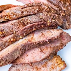 sliced steak on a white plate with seasoning