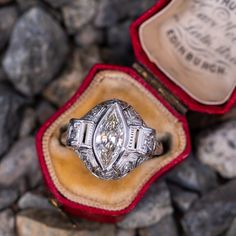 Circa 1930s ring features a pierced design and bordered with milgrain edging. Engraved details accent the shank. The ring is centered with one (1), bezel set, marquise brilliant cut diamond weighing 1.57 carats. The ring is accented with four (4), bead set, round brilliant cut diamonds, two (2), bead set, round single cut diamonds and six (6), bead set, rose cut diamonds. The ring measures 16.6mm at the top, rises 6.3mm above the finger, tapering to 1.5mm wide and 1.2mm thick at the base of the Gia Certified 14k White Gold Art Deco Ring, Gia Certified Marquise Platinum Rings, Gia Certified Platinum Marquise Rings, Gia Certified Diamond White Art Deco Rings, Gia Certified Art Deco Diamond White Rings, Gia Certified Art Deco White Gold Rings, Gia Certified Art Deco Platinum Rings, Gia Certified Platinum Art Deco Ring, Antique White Gold Gia Certified Diamond Ring