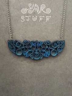 a necklace with blue swirls on it