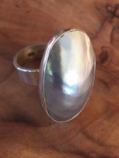 Absolutely stunning Nautilus Shell set in Mexican Sterling Silver. band fits 7-10. 35 mm Shell Silver Oval Pearl Ring With High Luster, Classic Adjustable Oval Pearl Ring, Modern Iridescent Round Ring, Modern Iridescent Round Rings, Classic High Luster Silver Ring, Nautilus Shell, Band Fits, Nautilus, Silver Band