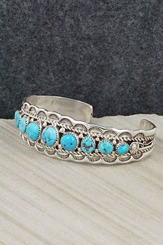 This Kingman turquoise and sterling silver bracelet was made by Navajo silversmith Anthony Brown. The inside is signed Anthony B and stamped sterling.Size: 5 3/8" (will fit up to a 6 3/8" wrist)Gap: 1"Width: 3/4"Free shipping on all orders! We ship with USPS and always include tracking. All orders ship within a day of payment.Returns are accepted up to 30 days after you receive your order. Just send us a message. Our shop offers cash back or store credit. The item must be returned in new conditi Southwestern Style Turquoise Bracelet Stamped 925, Southwestern Blue Cuff Bracelet Stamped 925, Western Style Blue Sterling Silver Bracelet Gift, Southwestern Style Stamped Blue Bracelets, Southwestern Blue Concho Bracelets, Southwestern Blue Sterling Silver Bangle Bracelet, Southwestern Blue Sterling Silver Bangle, Southwestern Style Blue Sterling Silver Bracelet, Southwestern Sterling Silver Cuff Bracelet In Blue