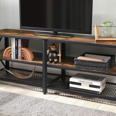 a flat screen tv sitting on top of a wooden shelf