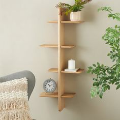 a living room with a chair, clock and potted plant on a shelf next to the wall