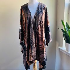 Earthy Brown Luxe Multi Media Print Kimono Wrap - One Size A Mix Of Vertically Paneled Exotic Florals And Abstract Burnout Prints In Earthy Browns, Purples, And Gold Give This Open-Front Kimono Wrap A Visually Appealing Luxe And Stylish Finish - Shark Bite Hemline. - 85% Polyester, 8% Rayon, 7% Spandex - Machine Wash - One Size Fits Most. Tag: Fall, Winter, Wrap, Kimono, Cover Up, Shawl, Bohemian, Boho, Funky, Multi Media, Witchy, Moody Floral, Earthy, Cover Up Shawl, Knit Poncho Sweater, Lace Shrug, Festival Outfits Rave, Turtleneck Poncho, Womens Poncho, Winter Wrap, Outfits Rave, Earthy Brown