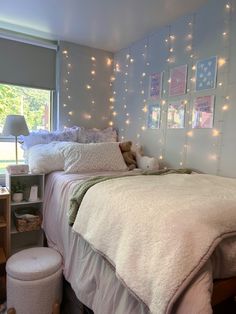 a bedroom with lights on the wall and a bed