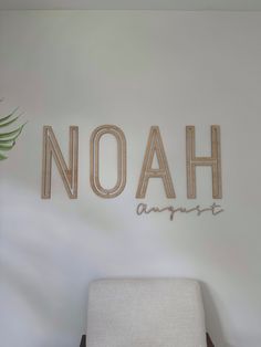 a chair sitting in front of a wall with the word noah on it's side