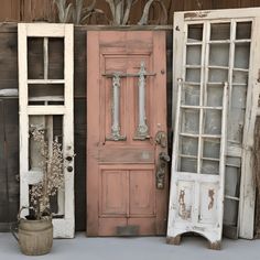 three old doors are sitting next to each other