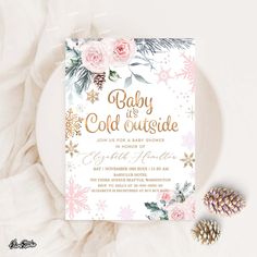 a baby is cold outside party with pink flowers and pine cones on the table next to it