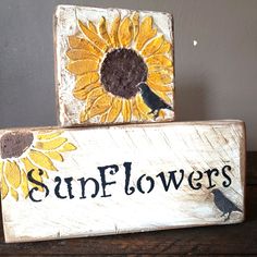 two wooden blocks with sunflowers painted on them and the words sunflowers