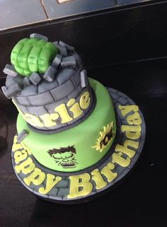 a birthday cake with green frosting and an image of the hulk face on top