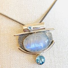 Sterling Silver Pendant With Large Oval Moonstone, And Round Blue Topaz Inlays. Chain Not Included. Dimensions: 32.9 Mm Width X 33.1 Length Moonstone Pendant, Jewelry Designs, Sterling Silver Pendant, Blue And Silver, Sterling Silver Pendants, Blue Topaz, Womens Jewelry Necklace, Silver Pendant, Moonstone