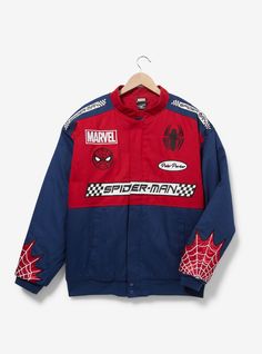 a jacket with spiderman patches on the front and back, hanging from a hanger