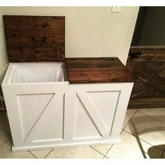 two wooden storage bins sitting on top of a tile floor next to a wall