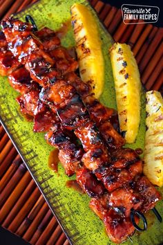 there are bananas and pineapples on the plate with kebabs in them