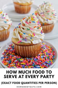 cupcakes with white frosting and sprinkles on plates