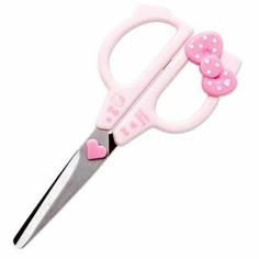 a pair of scissors with pink polka dots on the handle, and a bow at the end