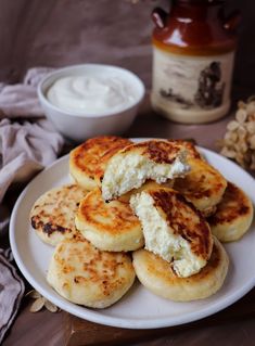 some food is on a white plate and next to a jar of yogurt