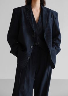 Color: Navy Pinstripe Midweight traditional suiting fabric Oversized silhouette Padded shoulders Flap front pockets Button front closure Lined 72% Polyester 22% Rayon 4% Wool 2% Spandex Dry Clean By The Frankie Shop. Imported One Size Product Measurements: 20" Shoulder 46" Bust 30" Length Model is wearing size O/S Designer Womens Suit, Navy Pinstripe Suit Women, Gender Fluid Formal Wear, Navy Suit Women, Pinstripe Suit Women, Pin Stripe Blazer, Suit Aesthetic, Stripe Suit, Tailored Vest