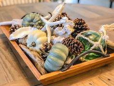 a wooden tray filled with lots of different types of decorations