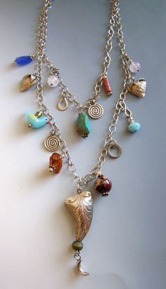 Very busy double sterling chain with charms, Central drop large curved pillow bead with bead and dangle moon charm.  Turquoise top charmwith glass bird, rose quartz beads, jasper charms, etc. Chain With Charms, Turquoise Top, Rose Quartz Beads, Very Busy, Quartz Beads, Moon Charm, Glass Birds, Rose Quartz, Charms