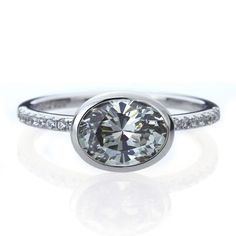 a white gold ring with a round cut diamond