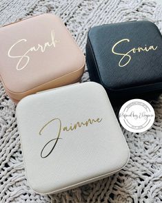 three personalized jewelry cases sitting on top of a blanket