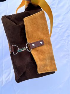 These hip bags have an adjustable soft strap allowing you to either wear it around your waist, or across your chest. These have a slim design so that they enter a room at the same time you do and not 2 steps ahead, and measure approximately 9.5"w by 2" d and 7" tall.   Closures are high quality hardware with a claw clasp and D ring design.  I have 3 variations: 1. Yellow velvet with silver hardware 2. Yellow velvet with gunmetal hardware 3. Faux cowhide with gunmetal hardware All bags have soft Brown Belt Bag With Adjustable Strap For Daily Use, Brown Belt Bag With Detachable Strap For On-the-go, Brown Adjustable Strap Belt Bag For Daily Use, Brown Chest Bag With Belt Loops For Daily Use, Brown Satchel Belt Bag With Adjustable Strap, Travel Pouch Shoulder Bag With Belt, Brown Belt Bag With Removable Belt For Daily Use, Versatile Brown Satchel Belt Bag, Brown Shoulder Bag With Removable Belt For Travel