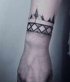 a black and white photo of a person's arm with a tattoo on it