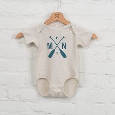 Introducing our Twin Lakes Onesie, the perfect gift for the little one in your life. This oatmeal onesie features a playful teal paddle graphic, making it cute and neutral essential. (Plus, it's so soft and cozy!) - 100% Cotton - Machine wash cold/tumble dry low - Designed and printed in USA - Imported Retail: $22 Key And Peele, Twin Lakes, Area Codes, Corporate Gifts, Summer Collection, Little One, Onesies, Oatmeal, Twins