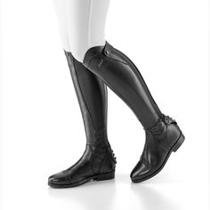 a woman in black riding boots and white pants