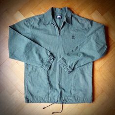 Rare vintage STUSSY quarter-zip overshirt in heavyweight woven cotton from early 90s. Green and black check with metal zip, buttoned cuffs and cord drawstring with toggles at the bottom edge. Unlined, with large set-in pockets and double panel at back neck. Stussy Broken Crown logo embroidery at the chest. Made in USA. In very good pre-loved condition. Size: Men's S Measurements: chest from underarm to underarm 23 inches Length at back from neck to edge of bottom hem 30 inches. Length of sleeve Vintage Stussy, Comfortable Skirts, Crown Logo, Early 90s, Green And Black, Logo Embroidery, Woven Cotton, Embroidery Logo, Cotton Weaving