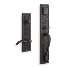 an iron door handle and latch on a white background, with the handles in black cast iron