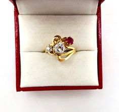 Contemporary Estate Custom 14K 585 Yellow Gold Diamond & Ruby Ring, Size 5 1/2. This is a custom made ring from three antique stones. The center largest stone is a 1/2 Carat Diamond. Flanked by a .20 Carat European Cut Diamond and a 1/4 carat antique ruby. Stunning design and color. The largest diamond is nearly flawless. The smaller diamond has a tiny chip. Would make a very creative engagement ring. The ring is hallmarked 14K for gold content. Weighs 4.3 grams. Excellent clean condition. C Heirloom 14k Gold Multi-stone Diamond Ring, Elegant Three Stone Collectible Ring, Collectible Multi-stone Yellow Gold Diamond Ring, Vintage Yellow Gold Three Stone Rings, Heirloom Multi-stone Diamond Ring In 14k Gold, Heirloom Three Stone Ruby And Diamond Ring, Heirloom Three Stone Ruby Ring With Diamonds, Heirloom Three-stone Ruby Ring With Diamonds, Heirloom Three-stone Ruby And Diamond Ring