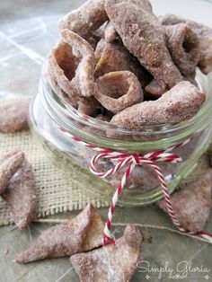 a glass jar filled with dog treats on top of a table