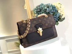 Gold Monogram Canvas Shoulder Bag With Chain Strap, Travel Shoulder Bag With Chain Strap And Monogram Canvas, Monogram Canvas Shoulder Bag With Chain Strap For Travel, Formal Monogram Canvas Bags With Lock, Louis Vuitton Luggage, Pocket Chain, Evening Accessories, Colored Leather, Chain Bag