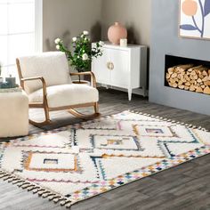 a living room with a rocking chair, fireplace and wood logs on the floor in front of it