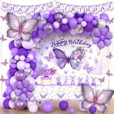 a birthday party with purple balloons and butterflies