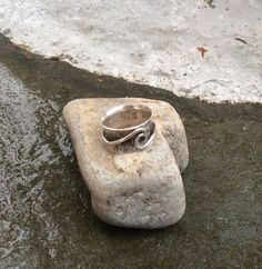 "Here is a new \"spin\" on my popular \"ocean wave\" ring. My sterling silver \"ocean wave\" ring spins around a hand formed and hammered sterling silver band making a unique spinner ring. I oxidize and hand polish it to bring out the rustic beauty of the silver. Great for those who like a chunkier style ring. The spinner ring measures 3/8\" wide. I custom make each ring for you upon ordering and it will leave my workbench and be on its way to you in 2-5 days. It will arrive in a little ribbon t Handmade Silver Wavy Jewelry, Silver Wavy Jewelry For Anniversary, Wavy Silver Jewelry For Anniversary, Wavy Silver Promise Ring, Spiral Sterling Silver Ring Stamped 925, Handmade Sterling Silver Spiral Rings, Adjustable Sterling Silver Wavy Rings, Hand Forged Silver Spiral Rings, Handmade Sterling Silver Swirl Rings