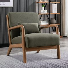 a chair with two pillows on it in front of a bookshelf