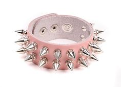 "Double Row 1/2\" Spiked wristband. This is a finely made leather wristband. It is made out of a heavy duty leather. The leather is available in Black, Red, Pink and white. The leather will get softer and more buttery with wear. This is a one-size fits all band. It will fit most wrists ( upto an 8\" wrist ). There are snaps for fastening. The 1/2\" Tall Spikes are a screwback design. These spikes are Solid Billet Aluminum This is a Punk/Rock themed piece. Its has a nice hardcore flair to it. A l Punk Leather Bracelet With Studs, Punk Style Studded Leather Bracelet, Rocker Leather Bracelet With Rivets For Festivals, Rocker Style Leather Bracelet With Rivets For Concert, Rock Style Wristband With Rivets For Concerts, Adjustable Leather Rivet Bracelet In Rocker Style, Adjustable Punk Wristband With Rivets, Rock Style Rivets Wristband For Festivals, Rock Style Wristband With Rivets For Festivals