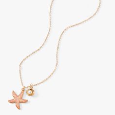 Hit the beach with laidback style and this pendant necklace. The gold-tone chain has a pink glitter embellished starfish charm and a faux pearl clam shell dangler for an added pop. Finish: Gold-tone Closure: Lobster clasp Length: 16'' + 3'' extender Material: Metal - Claire's Pink Starfish Pearl Gold Pendant Necklace Beach Starfish Charms Necklaces, Beach Charms Starfish Necklace, Beach Starfish Charms Necklace, Pink Starfish Charm Jewelry, Pink Star Jewelry With Starfish Charm, Pink Star-shaped Jewelry With Starfish Charm, Pearl Clam, Pink Starfish, Summer Wishlist