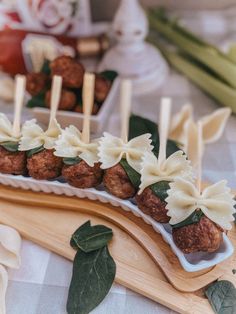 appetizers with meatballs and cheese are arranged on a platter, ready to be served