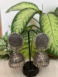 Silver -Toned dome shaped jumkas,silver plated secured with post and back . Material:-Brass  Style tips:- Match this silver plated pair with a maxi or flared dress for you next lunch date . Jumkas Silver, Silver Jhumkas For Eid Gift, Afghani Jhumka, Silver Dual-tone Bohemian Jhumkas, Ornate Silver Metal Jhumkas, Jaipur Jewelry, Phulkari Dupatta, 15% Off Sale, Deodorant Spray