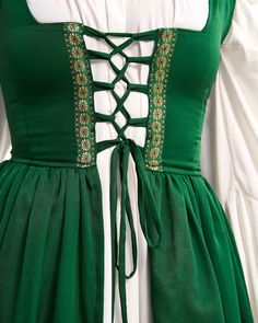 This costume set is perfect for the Renaissance Faire, featuring a 2-piece Irish dress and long-sleeved chemise. THE IRISH DRESS Get a perfect fit with the lace-up details on the bodice and shoulders of this dress. The brocade trim adds a beautiful touch, and the soft cotton-blend material is super comfy. Customize your fit with the adjustable back laces. THE MYTHIC STYLE CHEMISE Two flouncy flounces below the waist, charming long sleeves with mystical cuffs. One-size to be cinched down by overd Beautiful Sorceress, Halloween Gown, Irish Costumes, Irish Dress, Plain Skirt, Plain Dress, Medieval Dress, Cream Dress, Dress Plus Size