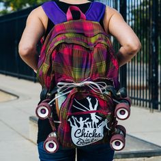 the back of a person wearing a backpack with roller skates on it