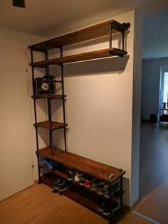 an empty room with shelves and shoes on the floor